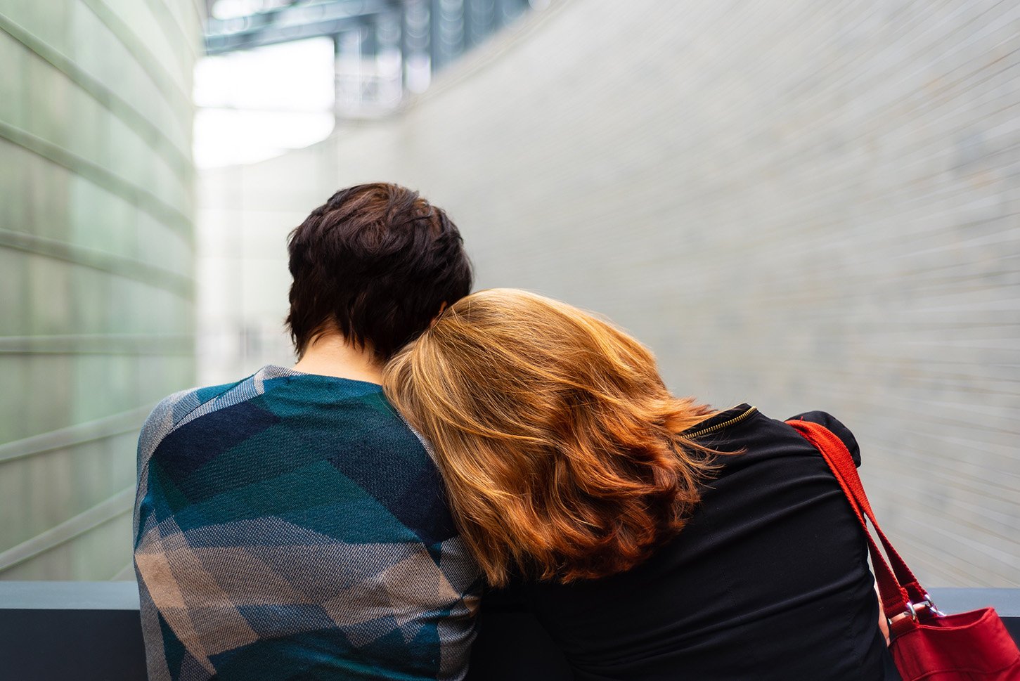 A person leaning on the shoulder of another person