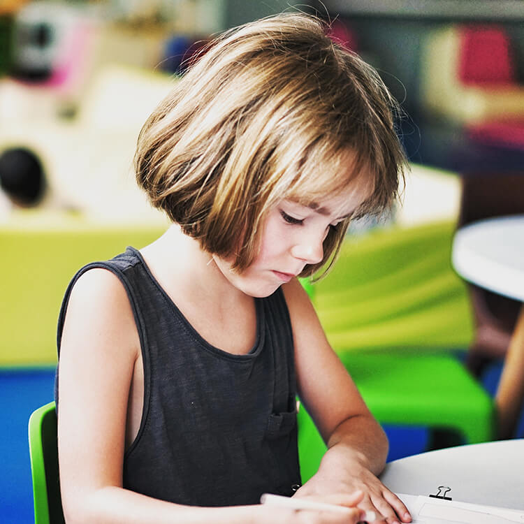 Child writing at desk